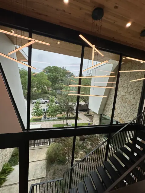 Large commercial stairwell windows with clean glass and architectural lighting
