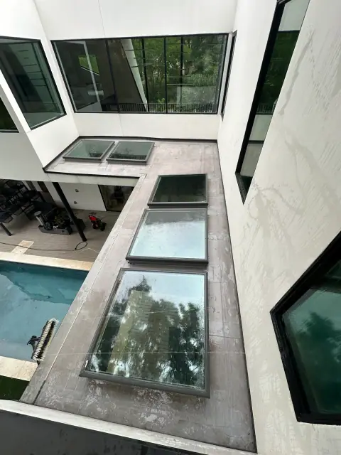 Modern estate courtyard with large skylight glass and exterior windows after washing