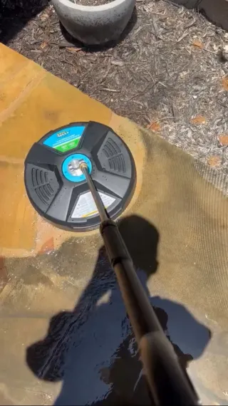 Pressure washing surface cleaner washing an Austin patio and walkway