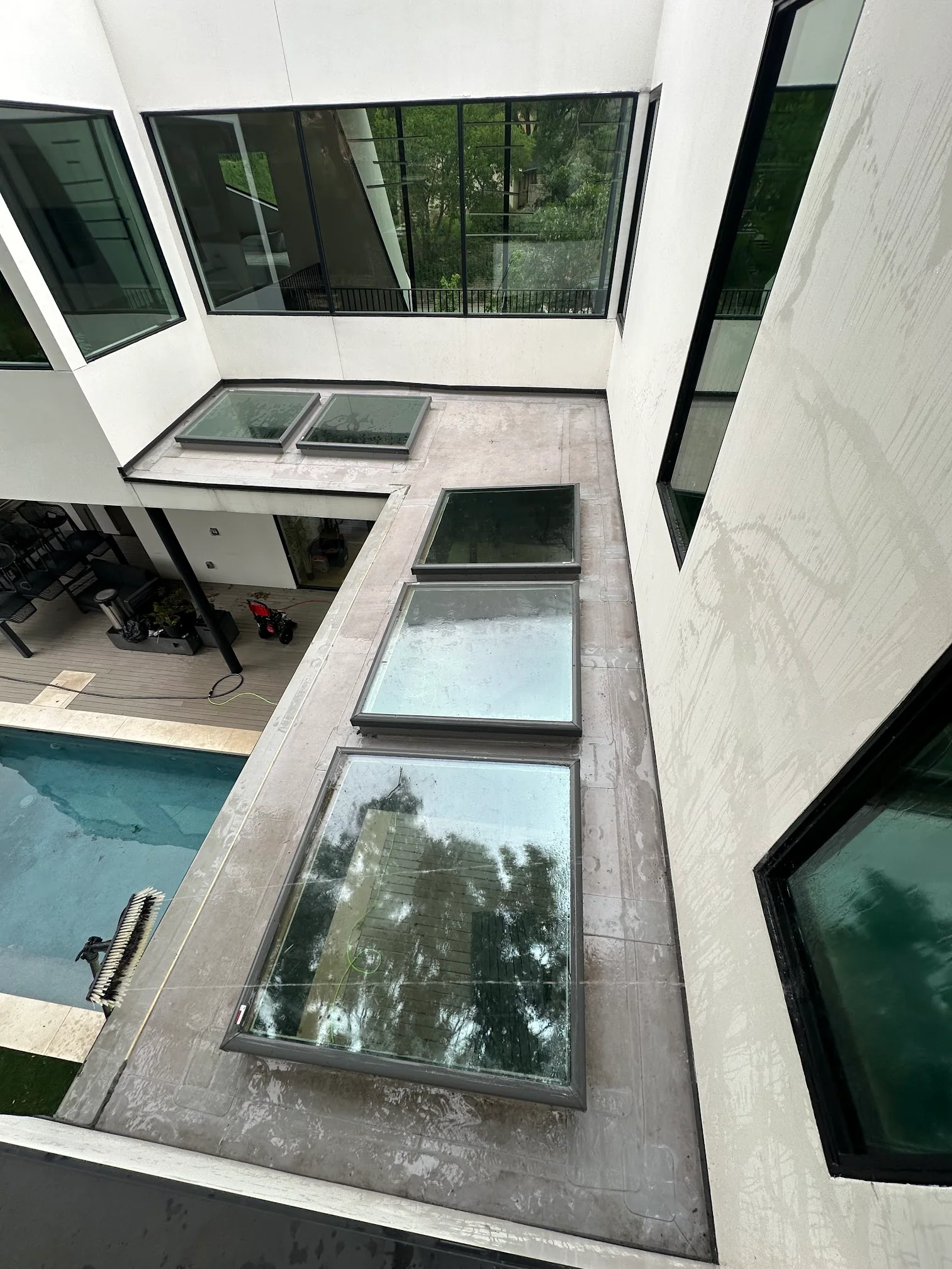 Modern estate courtyard with large skylight glass and exterior windows after washing