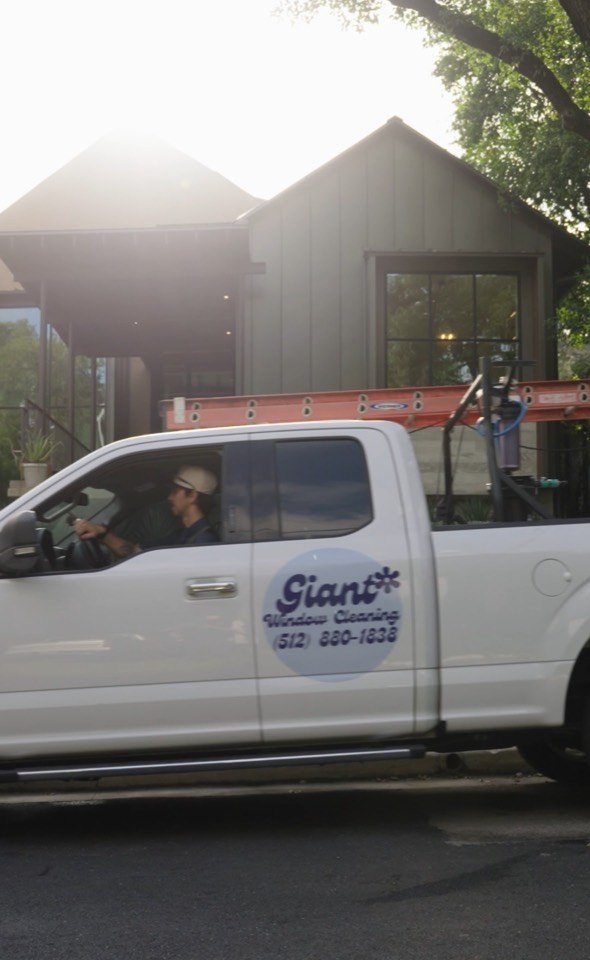 Branded Giant Window Cleaning truck arriving at an Austin home