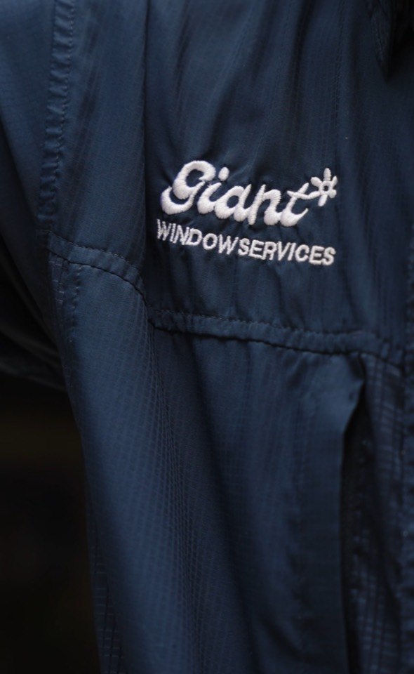 Close view of Giant Window Services workwear during a window cleaning job